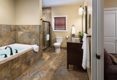 Large tub, separate shower, toilet, vanity, and towel racks